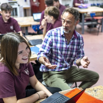 Student laughing with teacher